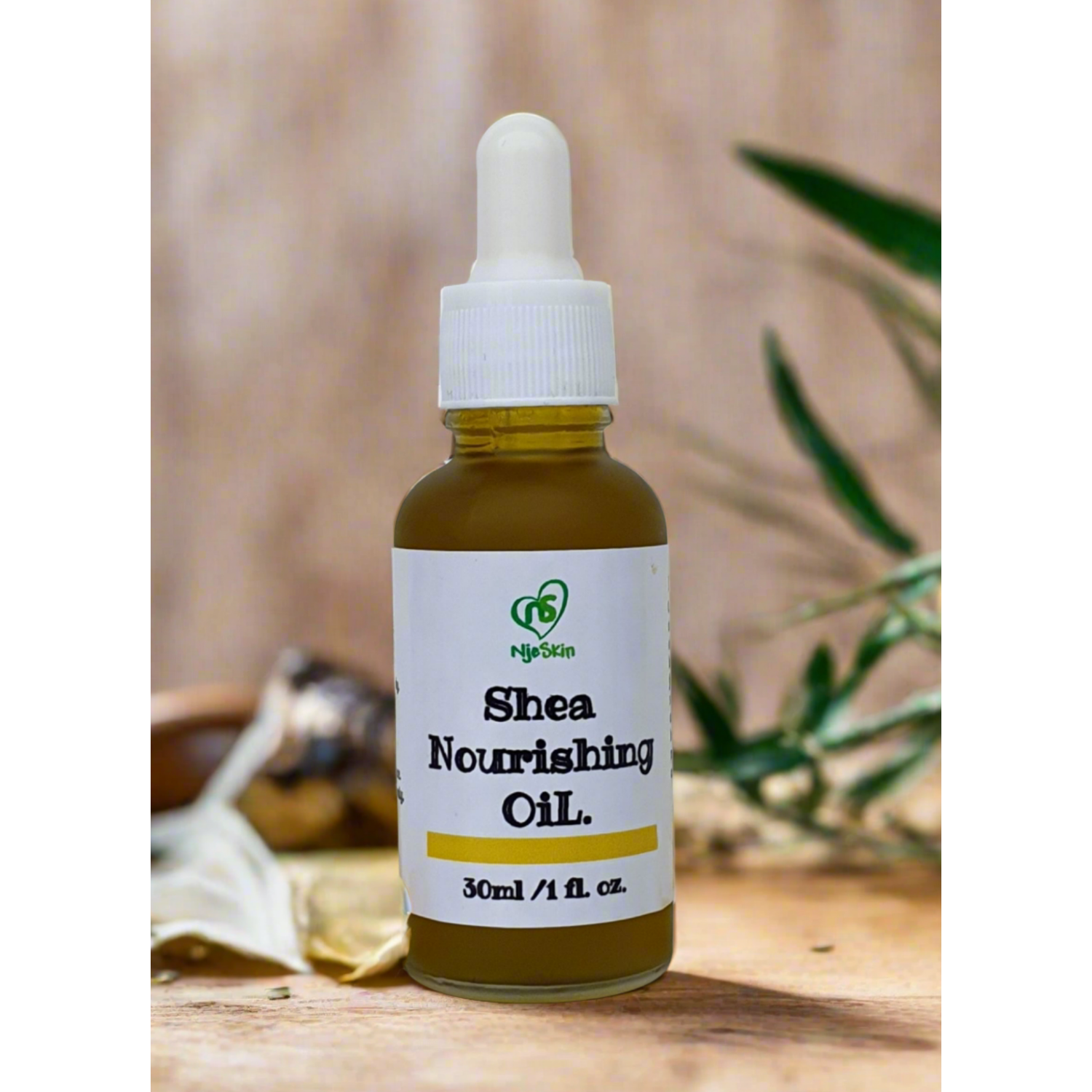 A bottle of Shea Nourishing Oil with a dropper, labeled with the brand Njeskin and the product name clearly visible.